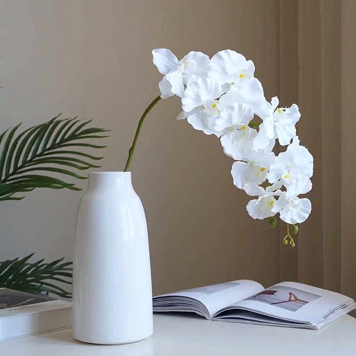 Silk Phalaenopsis Orchids by Allthingscurated feature dynamic blooms with vivid details and texture that will add a touch of understated elegance and charm to your living space. These graceful beauties come in 5 mesmerizing colors.