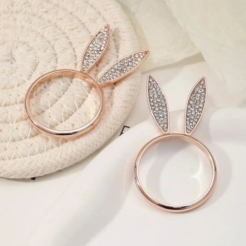 These sparkling Bunny Ear Napkin Rings (set of 6) by Allthingscurated add a cute and whimsical touch to your Easter table setting. Made of metal and encrusted with rhinestones, they come in gold, silver, and rose gold. Elevate your dining experience with these charming and sparkly napkin rings.