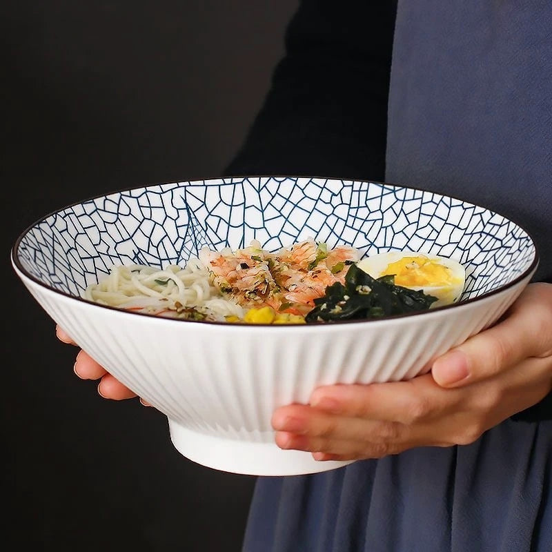 This Blue and White Japanese Ramen Bowls by Allthingscurated feature a modern, Asian design in a conical shape with a white fluted exterior, the porcelain bowls spot a beautiful, Japanese-inspired print for the interior. Comes in 4 different designs, this versatile bowl is not just for ramen, but also great for soups, curries and salads.