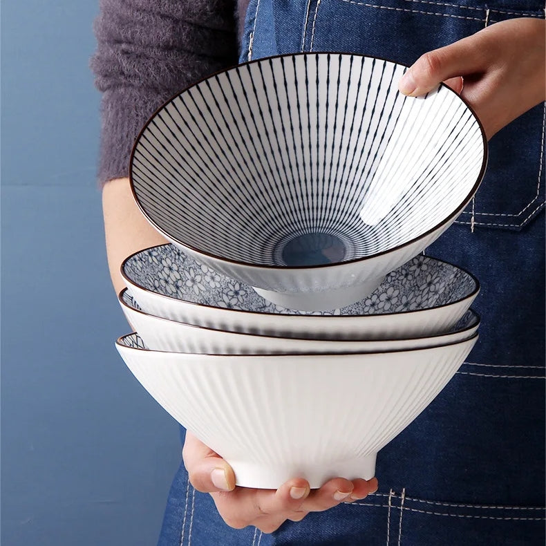 This Blue and White Japanese Ramen Bowls by Allthingscurated feature a modern, Asian design in a conical shape with a white fluted exterior, the porcelain bowls spot a beautiful, Japanese-inspired print for the interior. Comes in 4 different designs, this versatile bowl is not just for ramen, but also great for soups, curries and salads.