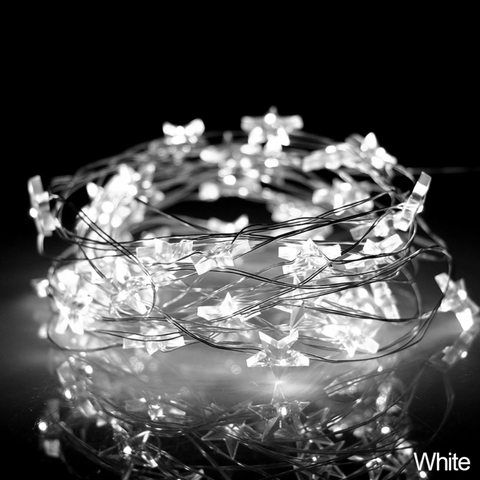 Mini Stars LED Fairy Lights by Althingscurated. Create a cozy and festive atmosphere with these decorative lights that offer a warm, tinkling glow. These mini stars are attached to silver wire that is bendable and easy to manipulate so you can fit them into tiny spaces or wrap around objects to enhance your favorite decorations.  Comes in 6 different lengths from 1 meters to 6 meters or 39 to 236 inches. Available in warm white or white lights. Featured here is the white light.