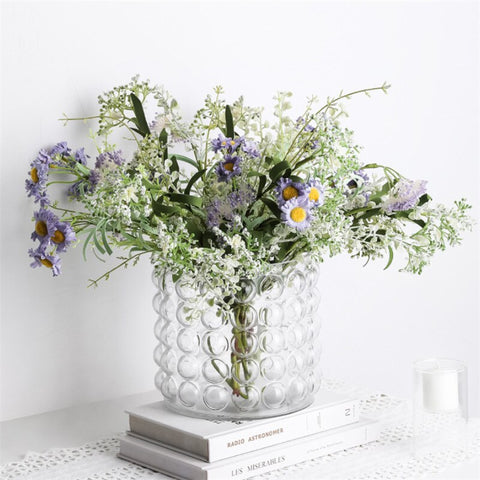 Zayla Bubble Vase by Allthingscurated features a geometric bubble design. The eye-catching detail and design are enough to make it a statement centerpiece with or without floral display. Comes in black or clear and in 2 sizes. The short vase measures 17cm or 6.6 inches in height and 16cm or 6.2 inches in diameter.  The tall vase measures 27.5cm or 10.7 inches in height and 13cm or 5 inches in diameter. This is a short clear vase with a mixture of flowers.
