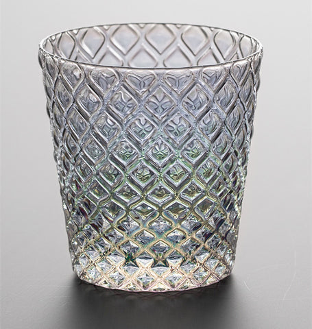 Carven geometric glass tumblers by Allthingscurated spots a unique design resembling the exterior of a pineapple.  An elegant and charming drinkware for serving cocktails, whiskey and sangria to you guests. Come available in clear or iridescent glass with height measuring 7.6cm or 3 inches by top diameter of 7.3cm or 2.8 inches and base diameter of 5.2cm or 2 inches. This is an iridescent tumbler.