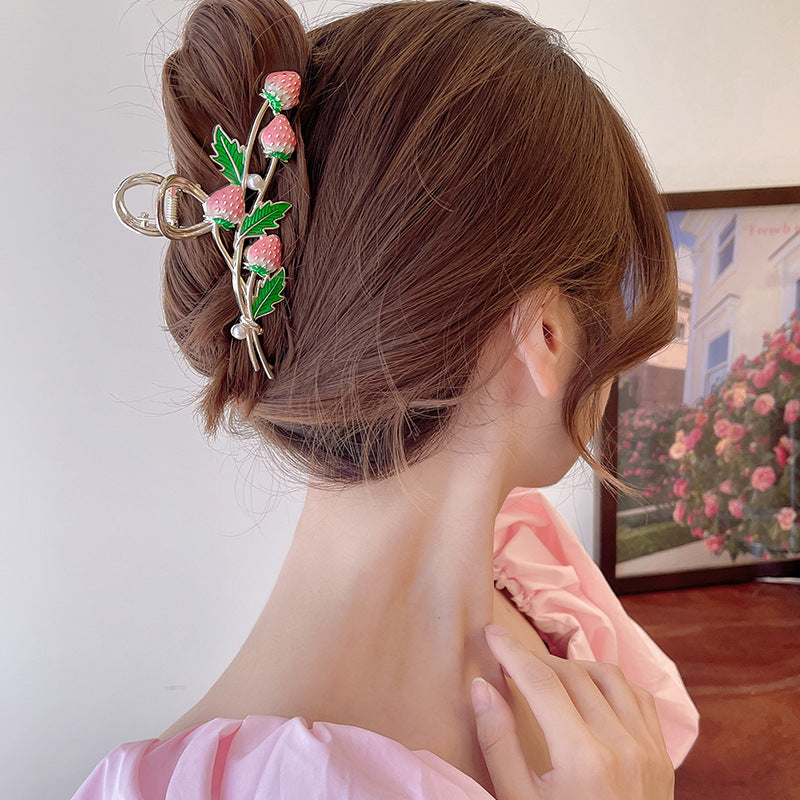 hairstyle using a metal claw clip in a shape of a strawberry bouquet