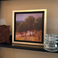 Framed landscape on shelf