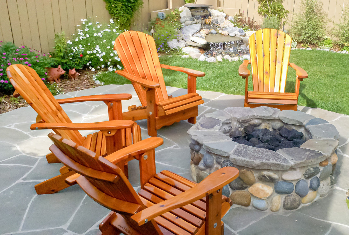 Knotted cedar Adirondack chairs in backyard