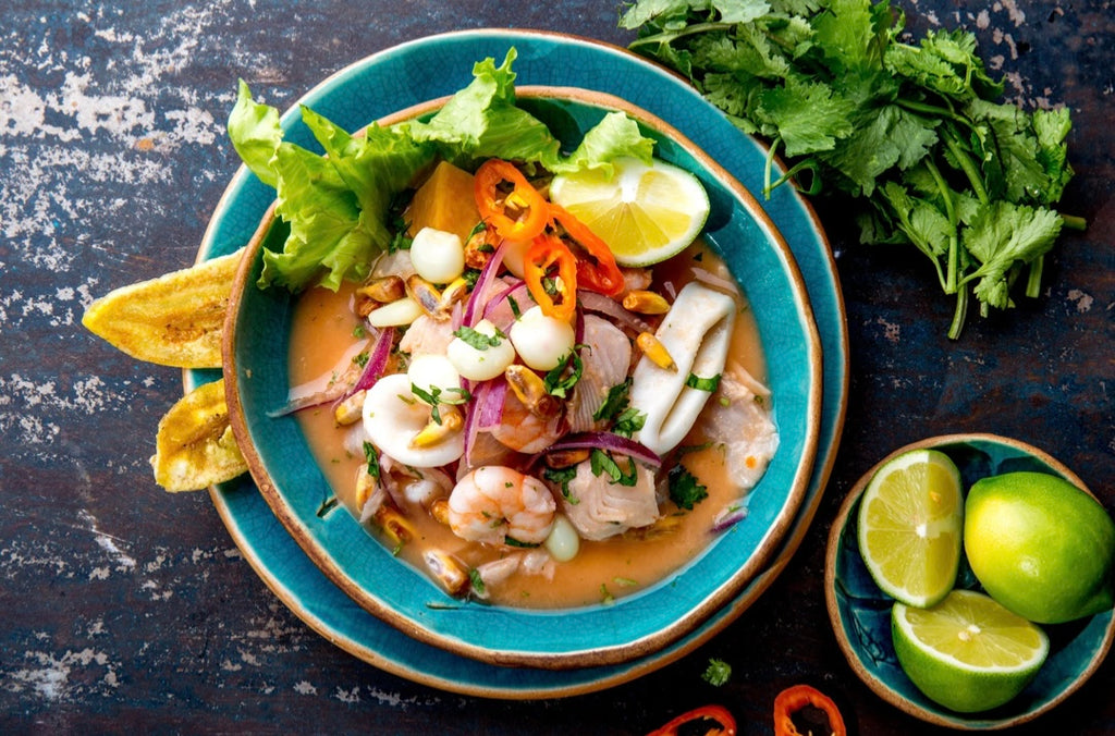 A bowl of Ceviche with raw seafood and vegetables