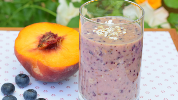 A glass of blueberry peach smoothie