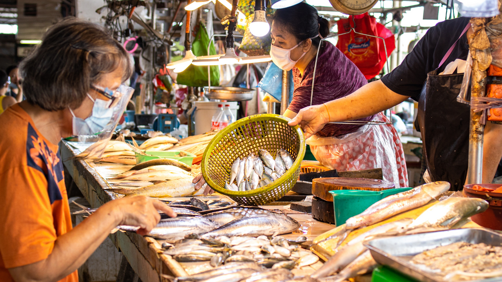 A woman buying fresh seafood at the wet market
