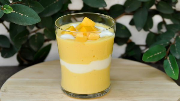 A glass of mango and lychee smoothie