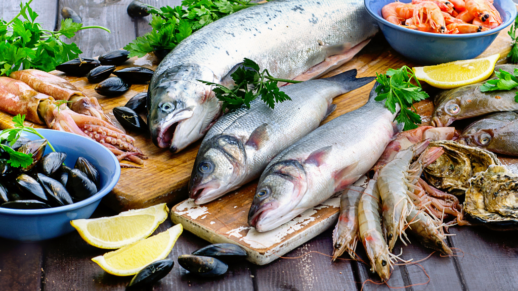 Various fresh seafood on a wooden board