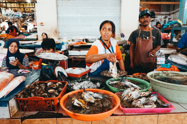 A vendor selling different kinds of fish in the market