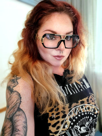 woman wearing black and gold gazelle glasses