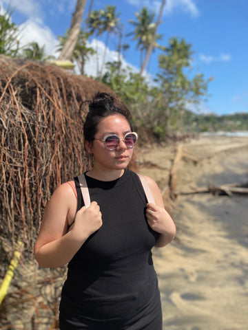 woman on beach wearing heart shape sunglasses