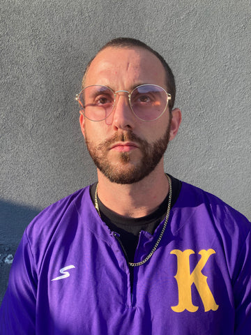 man wearing purple round sunglasses