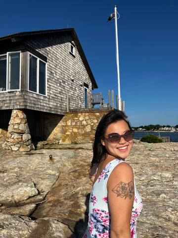 woman in nantucket wearing a dress and cat eye sunglasses