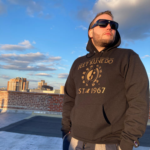 man on rooftop wearing square sunglasses