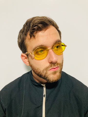 man wearing gold and yellow round sunglasses