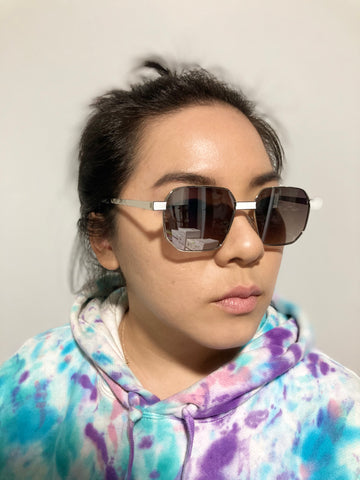 woman wearing tie dye hoodie and square sunglasses