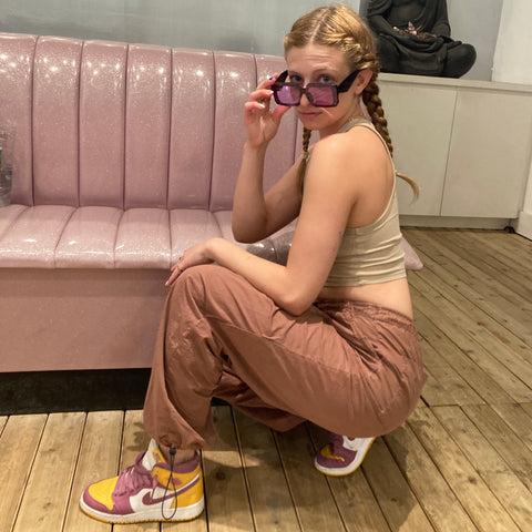 blonde girl wearing purple sunglasses and jordan 1s