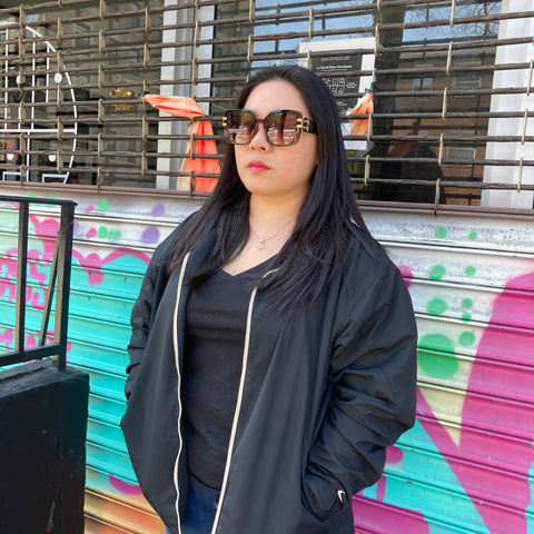 woman on nyc street wearing oversize sunglasses