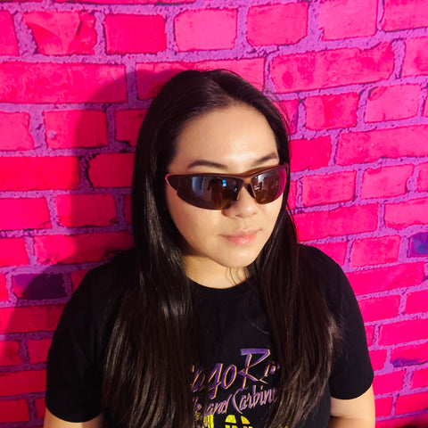 woman wearing black t shirt and wrap around sunglasses