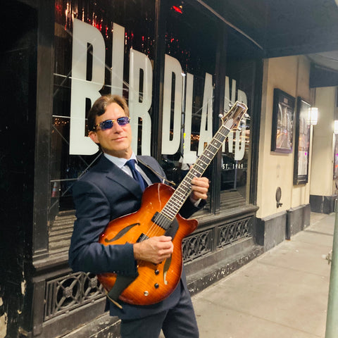 jazz musician frank vignola wearing blue square sunglasses