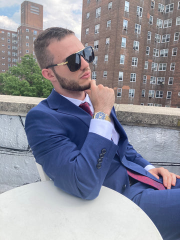 man in suit wearing aviator sunglasses