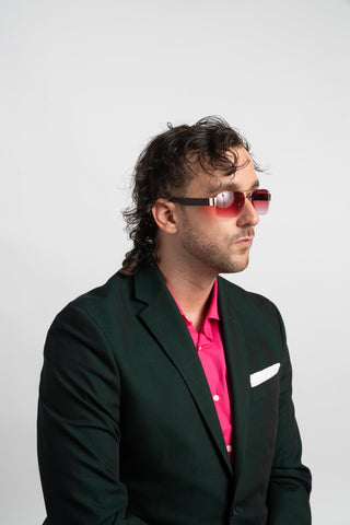 man in suit wearing red sunglasses