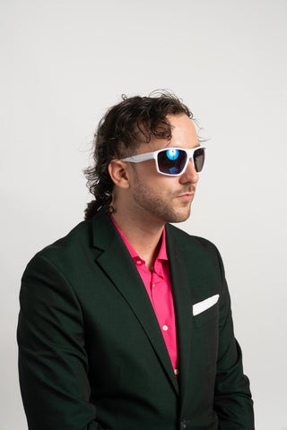 man in suit wearing wrap around sunglasses