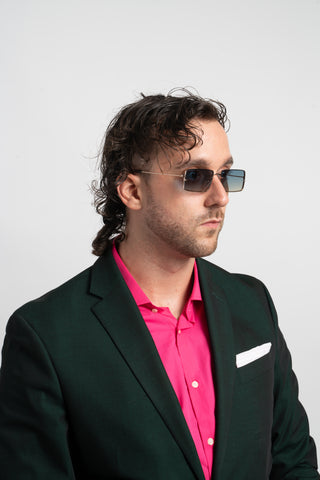 man in green suit wearing retro square sunglasses