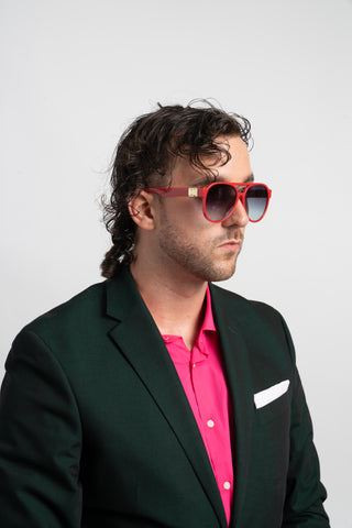 man wearing green suit and red aviator sunglasses