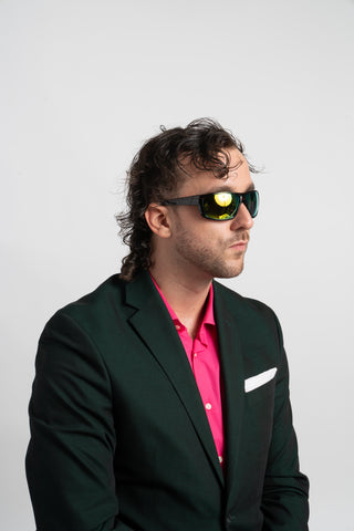 man wearing green suit and mirrored sunglasses