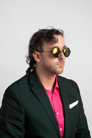 man wearing green suit and mirrored sunglasses