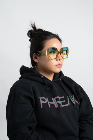 woman wearing oversize square sunglasses