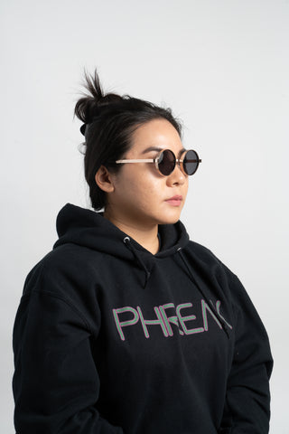 woman wearing black hoodie and gold round steampunk sunglasses
