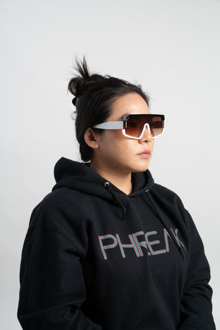 woman wearing black hoodie and brown futuristic square sunglasses