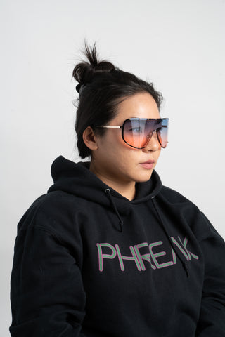 woman wearing black phreak hoodie and oversize shield sunglasses