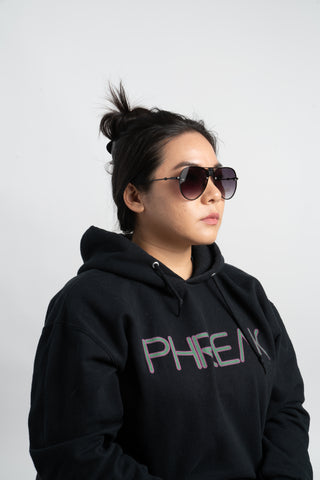 woman wearing black phreak hoodie and aviator sunglasses