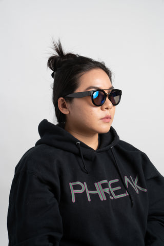 woman wearing black hoodie and round sunglasses