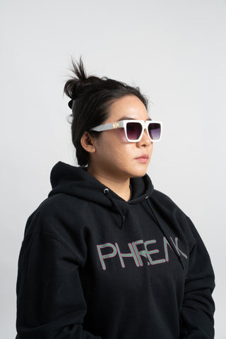 woman wearing black phreak hoodie and white square sunglasses