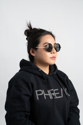 woman wearing black phreak hoodie and round sunglasses with side shield