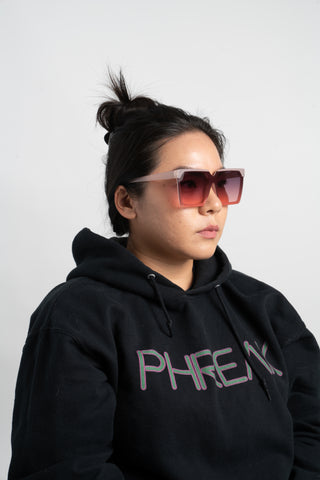 woman wearing black hoodie and square sunglasses