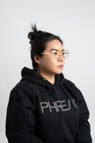 woman wearing black phreak hoodie and square sunglasses