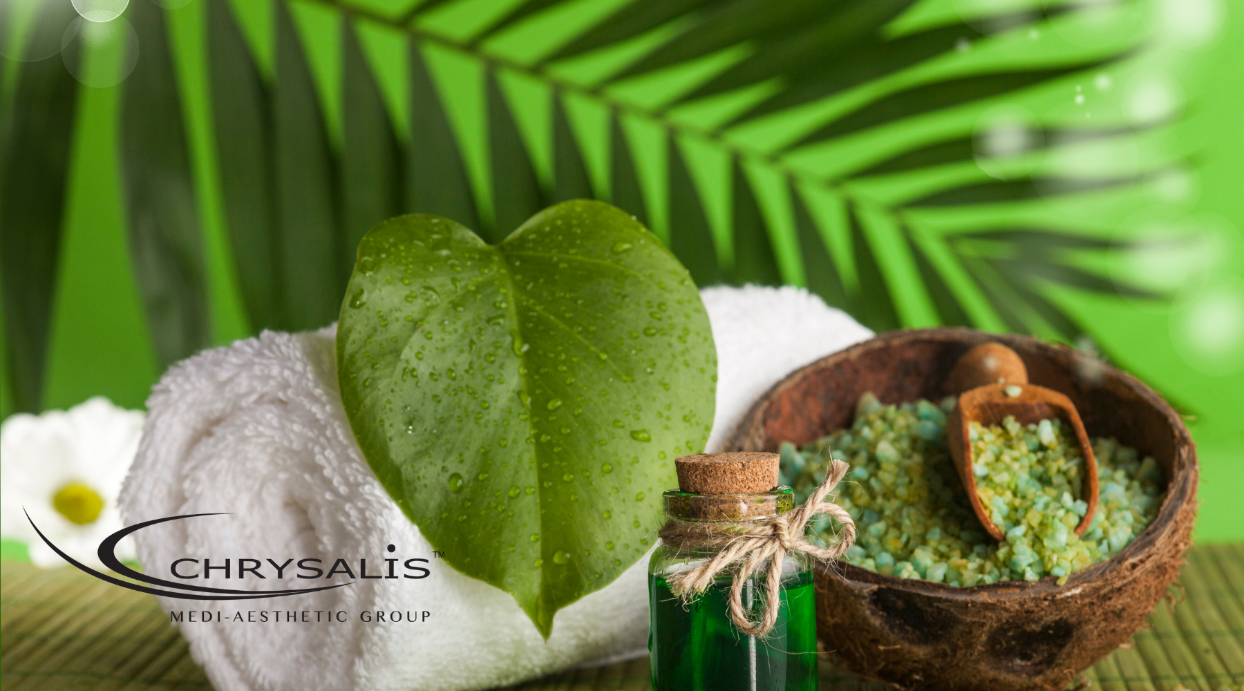 A serene spa room with a comfortable massage bed, featuring aromatic oils and scrub products ready for a body scrub and massage session in Singapore