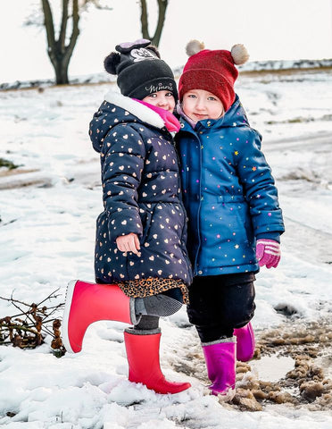 Term Footwear kids wellies with sock liners being worn in the snow by two girls.