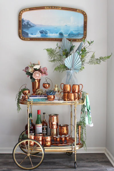 brass bar cart with copper accessories
