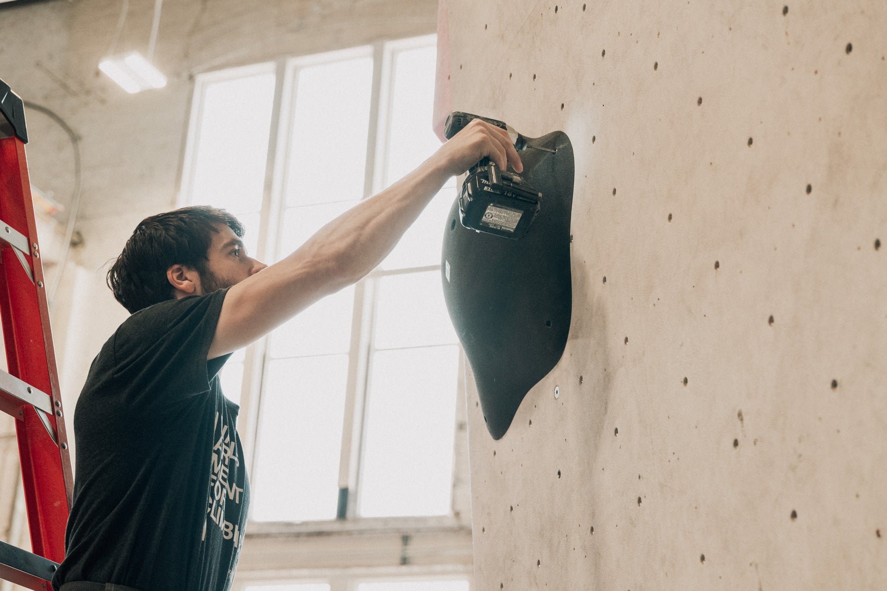 a route setter uses the so ill bubbies to set a route at climb so ill