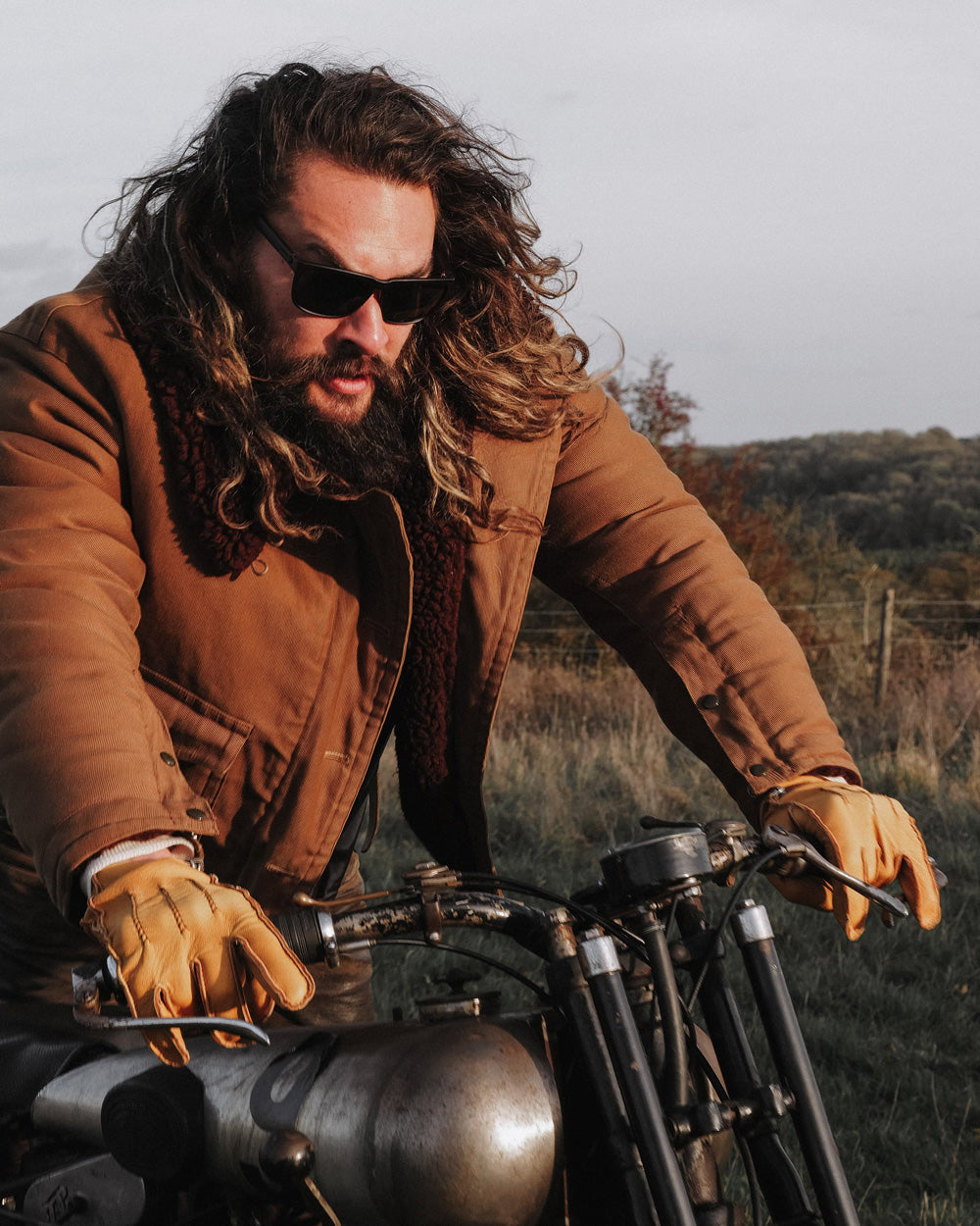 So iLL x On The Roam x Electric sunglasses by jason momoa shown being worn by jason momoa on a motorcycle