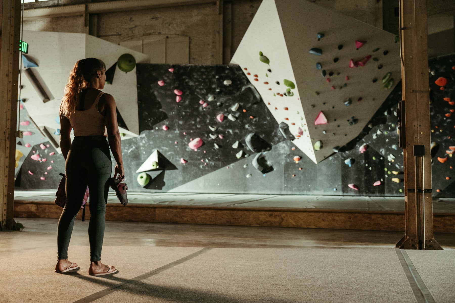 a woman climbs in the So iLL x Meagan Martin forest denim